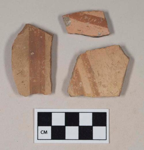 Red bodied earthenware body sherds, with red slipped stripes, reduced core