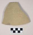 Coarse gray bodied earthenware body sherd, with green slip