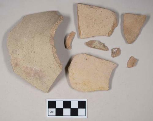 Coarse red bodied earthenware body sherds, with buff slip