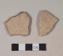 Coarse buff bodied earthenware body sherds, unslipped, reduced core; two sherds crossmend