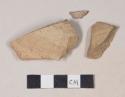 Coarse brown bodied earthenware body sherds, with buff slip; two sherds crossmend