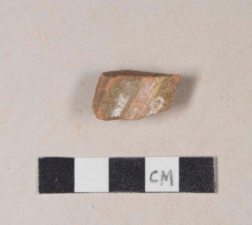 Slip decorated, lead glazed redware base sherd