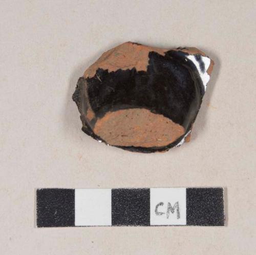 Undecorated lead glazed redware body and handle sherd