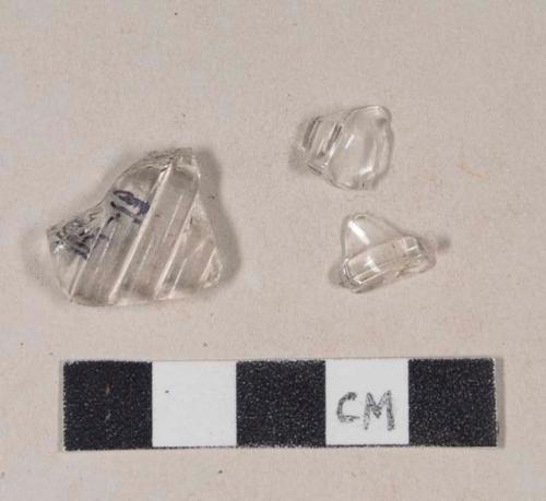 Molded colorless bottle glass fragments; two fragments crossmend