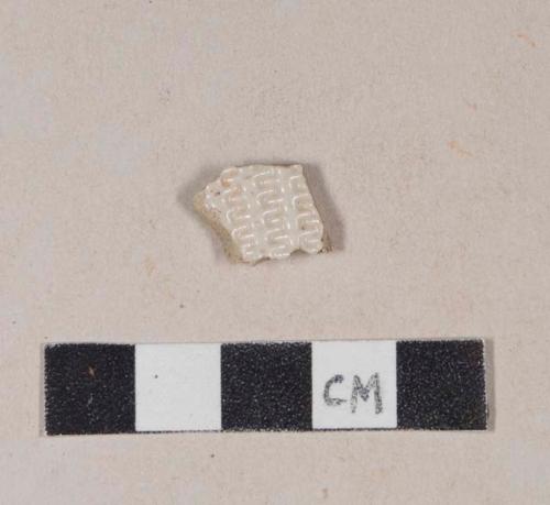 White salt glaze stoneware body sherd, molded in "dot, diaper, and basket" pattern