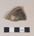 Undecorated lead glazed redware base sherd