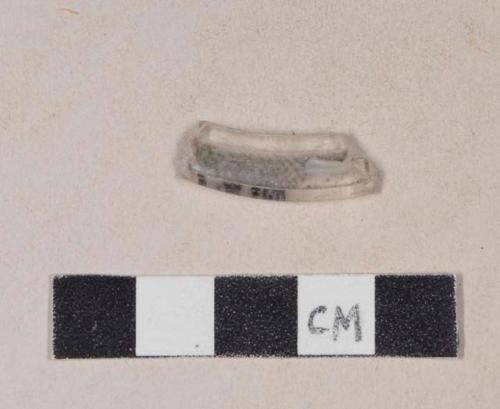 Folded colorless glass fragment, possibly fragment of stemware base