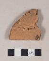 Undecorated lead glazed redware rim sherd; two sherds crossmended with glue