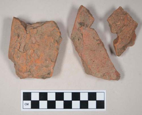 Redware roof tile fragments, some with nail holes