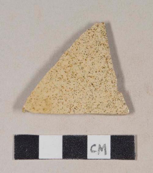 Refined earthenware body sherd with speckled yellow glaze