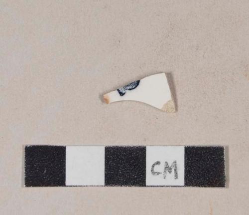 Whiteware body sherd with fragment of black transfer printed makers mark