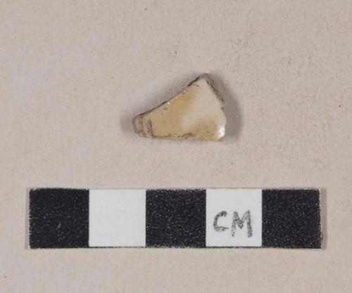 Buff-bodied, bristol glazed stoneware body sherd with yellow slip