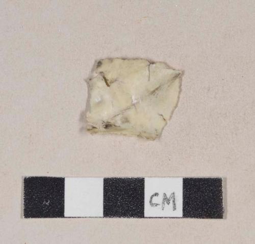 Cream-colored plastic fragment