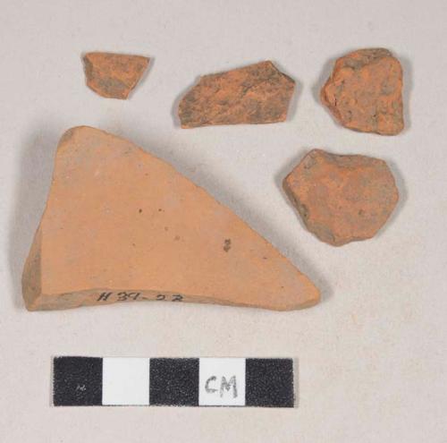 Unglazed, undecorated redware body sherds; two sherds crossmend