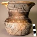 Restored black stick polished flaring necked pottery jar.