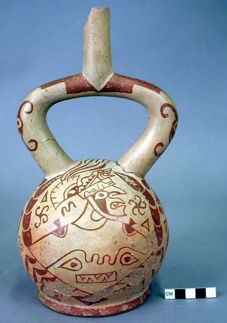 Red and white stirrup pot, fanged anthropomorphic figure battling a sea monster