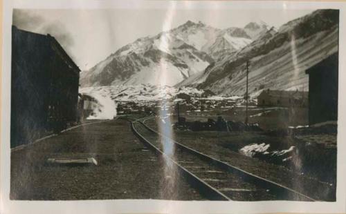 Train station, snowy peaks in background