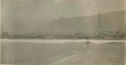 Town and mountains rising from the water