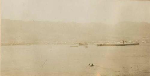 Town and mountains rising from the water