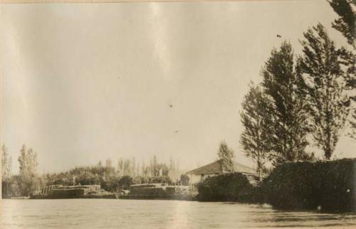 Lumber stacks on a shore