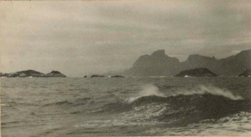 Islands, with shoreline and mountains in background