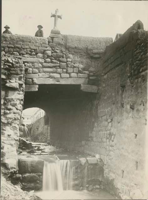 Water flowing under brick bridges