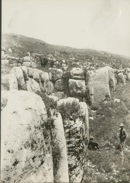 Two men next to wall