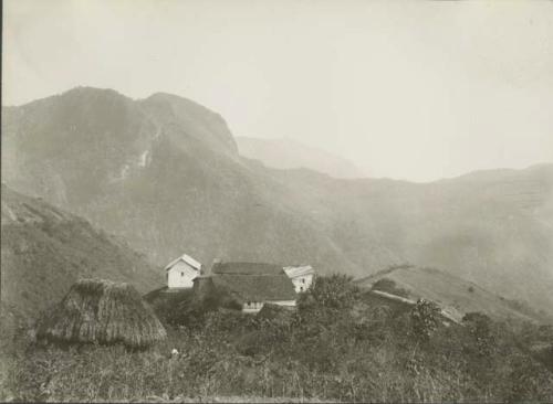 Houses, with valley and mountains in background