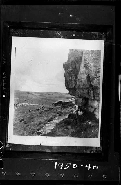 Men sitting in front of an entrance to a cave at Poggenpool Farm