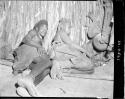 Man and woman resting inside a hut