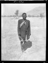 Man wearing a sash of office, standing