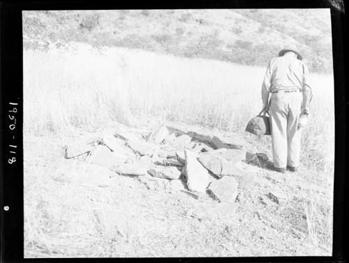 Laurence Marshall looking at a dwelling site