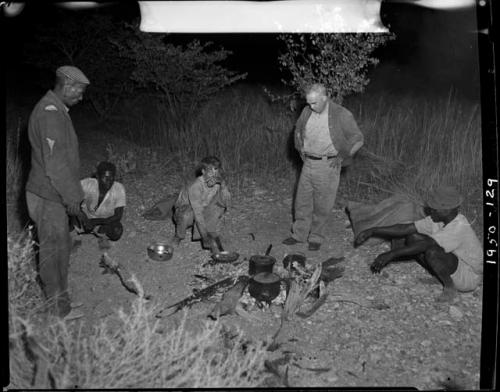 Edward Hartley, John Marshall, Laurence Marshall and two other expedition members in camp at night