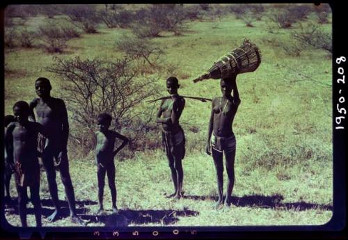 People standing and holding fishing gear