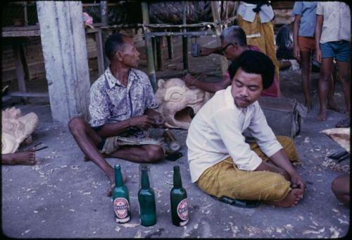 Men taking a break from cremation preparations