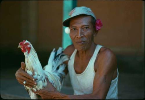 Portrait of a man with a rooster