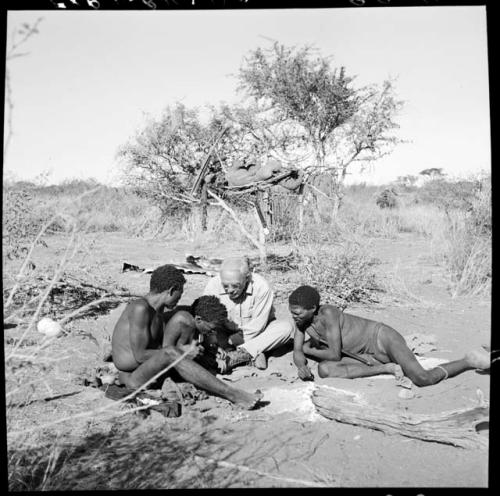 ≠Toma mending Laurence Marshall's boot, with "Old Gau" and "Gao Medicine" watching him