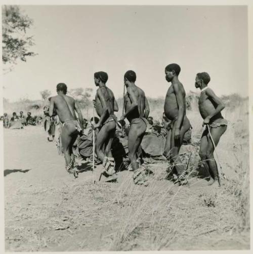 Group of men performing a curing dance, including Gau of Band 2 (right), "/Gao Music" (second from left), ≠Toma (fourth from the left, a visitor, son of !Naishi and //Khuga)