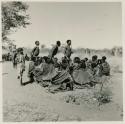 Gau, ≠Toma (son of !Naishi), and /Ti!kay resuming a curing dance after a rest, cutting across a circle of seated women