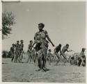 Woman dancing, with a group of people dancing behind her