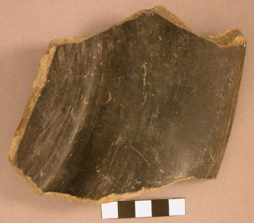 Polished black incised fragment of a flat-bottomed sloping-sided pottery bowl