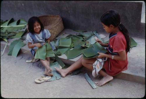 Children making banana-leaf plates