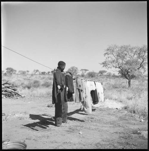 Member of expedition staff hanging clothes