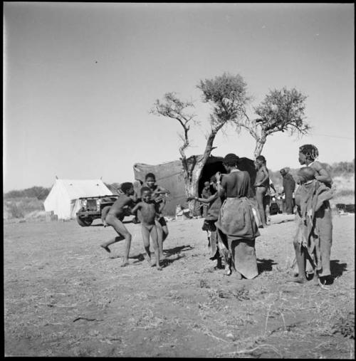 Group of boys playing a game, and women watching