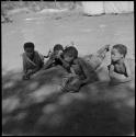 ≠Toma (son of Gau) playing the //guashi, with "≠Gao Lame," an unidentified boy and Tsamgao listening to him