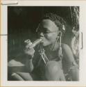 Bau (daughter of /Ti!kay) smoking a soapstone pipe