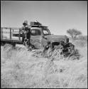 Boys being recorded by Hans Ernst, who is sitting in an expedition truck