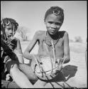 Boy playing a //guashi, with a girl sitting beside him