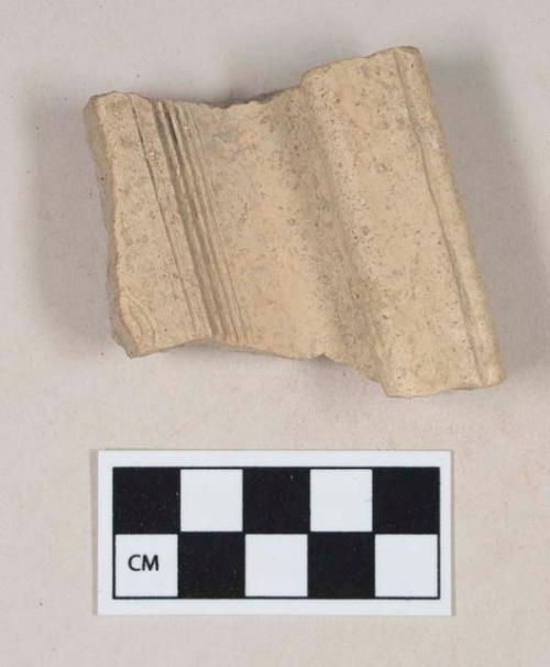 Coarse buff bodied earthenware rim sherd, with buff slip and incised decorations