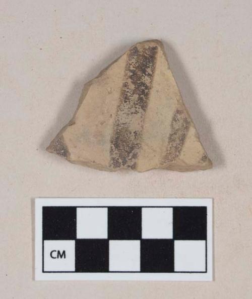 Coarse buff bodied earthenware body sherd, with buff slip and brown slipped stripes